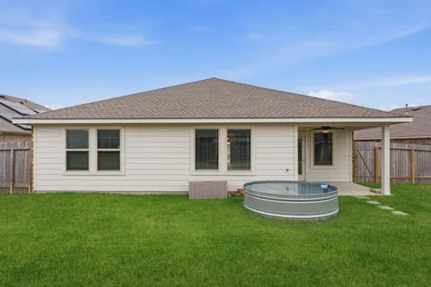 a view of a house with a backyard