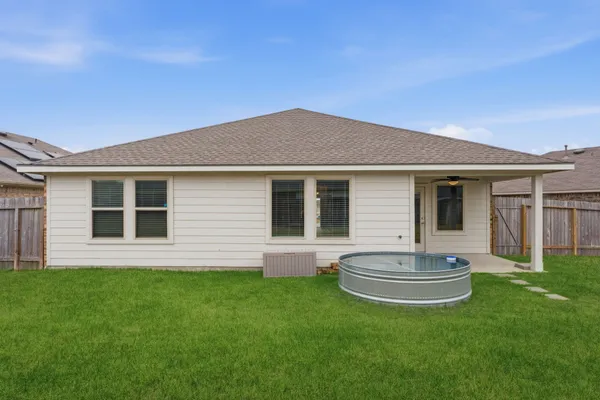 a view of a house with a backyard