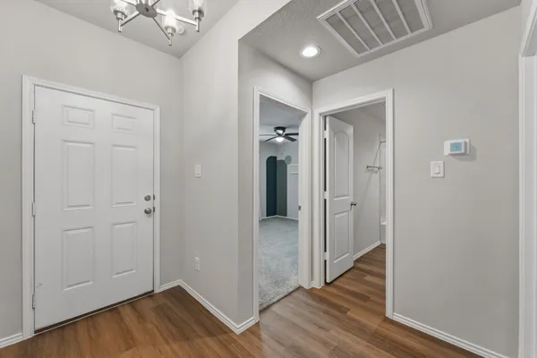 a view of a hallway with wooden floor