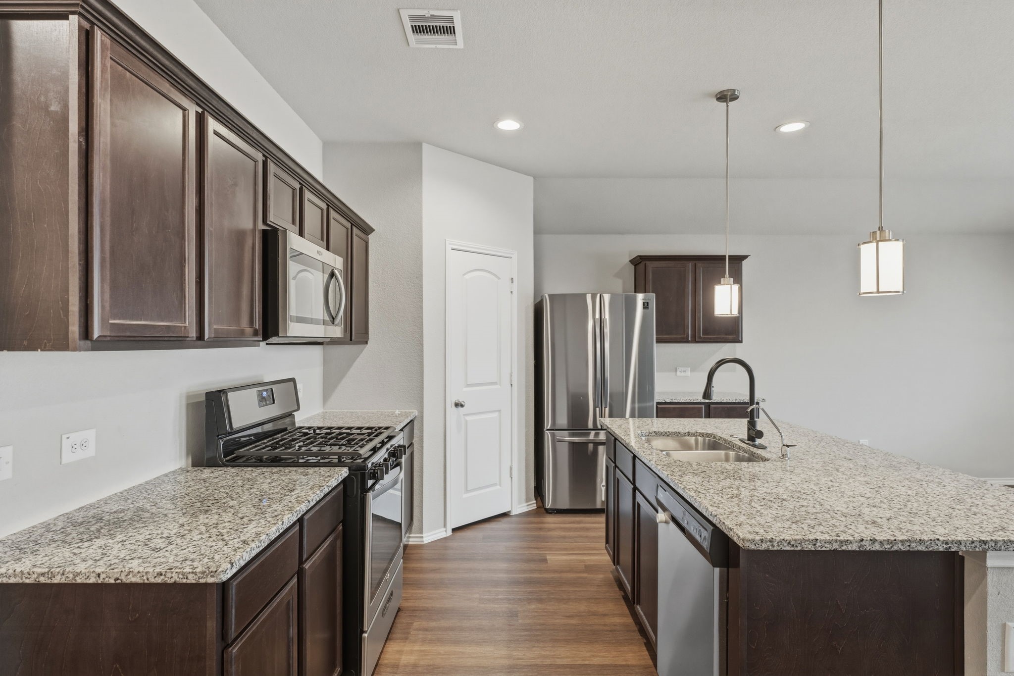 2407 Staverton Cir Spring Spring, TX 77373 - Photo 10 of 41 a kitchen with stainless steel appliances granite countertop a kitchen island a stove and a sink