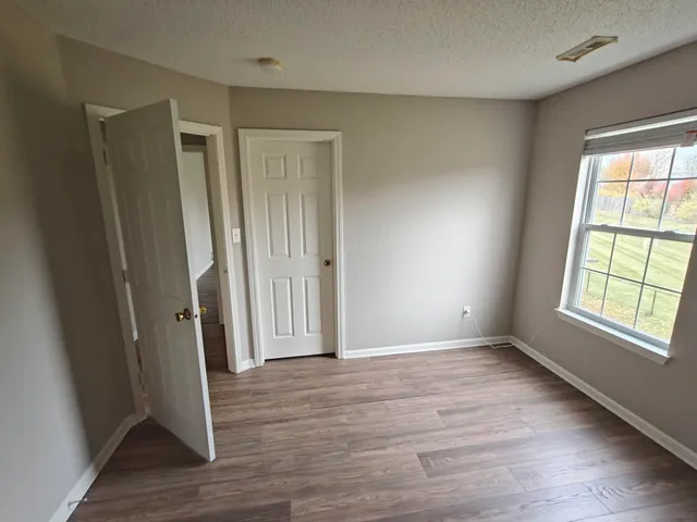 a view of entryway and hall with wooden floor