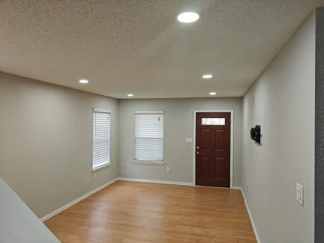 an empty room with windows and closet