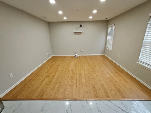 an empty room with wooden floor