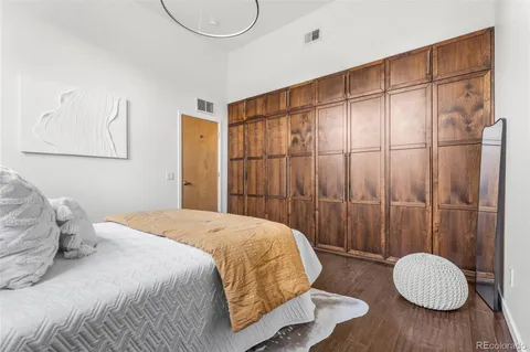 a bedroom with a bed and a chandelier