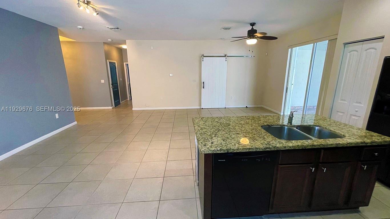 22912 Southwest 115th Court Miami, FL 33170 - Photo 12 of 29 a bathroom with a granite countertop sink and a mirror