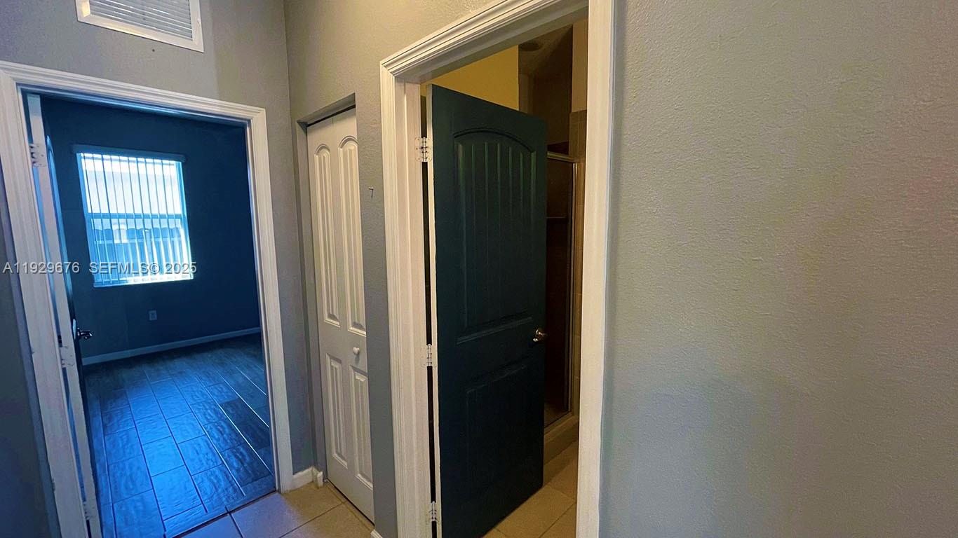 22912 Southwest 115th Court Miami, FL 33170 - Photo 19 of 29 a view of a hallway with wooden floor and closet