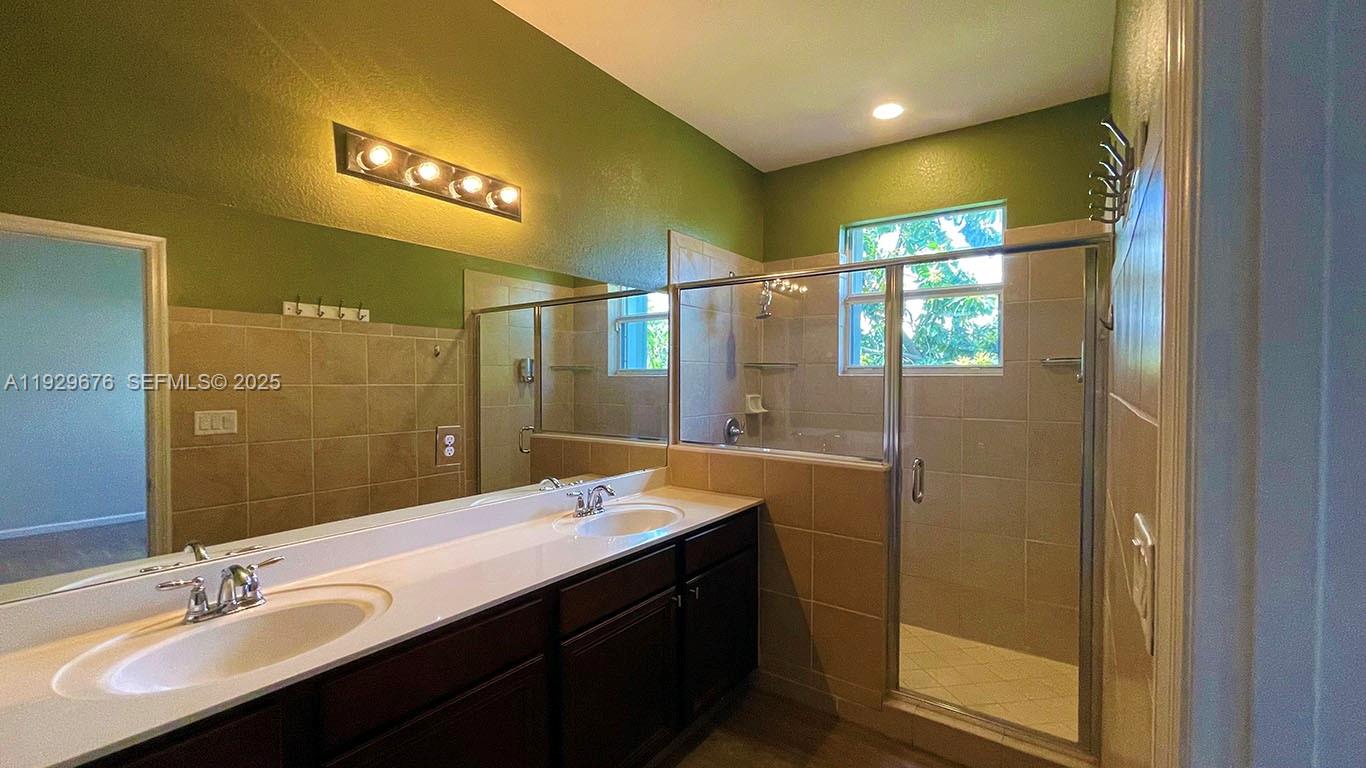 22912 Southwest 115th Court Miami, FL 33170 - Photo 24 of 29 a bathroom with a double vanity sink and a mirror