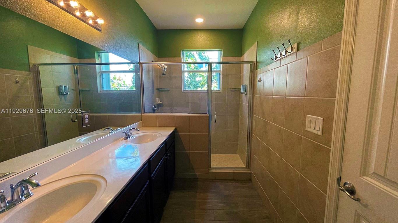 22912 Southwest 115th Court Miami, FL 33170 - Photo 26 of 29 a bathroom with a double vanity sink and a mirror