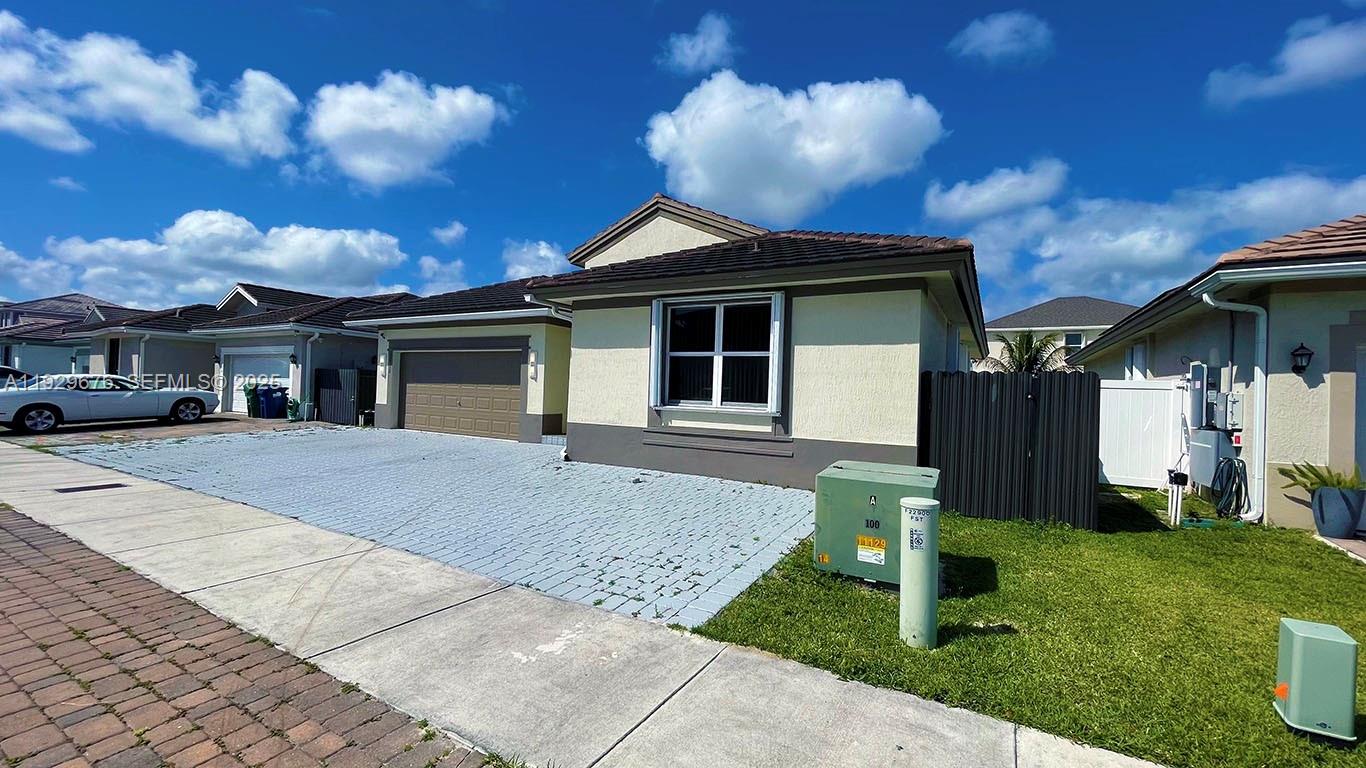 22912 Southwest 115th Court Miami, FL 33170 - Photo 3 of 29 a front view of a house with a yard