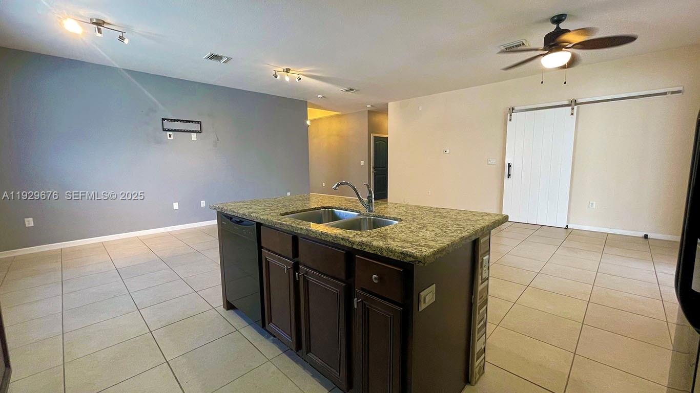 22912 Southwest 115th Court Miami, FL 33170 - Photo 10 of 29 a kitchen with kitchen island a sink a stove a refrigerator and cabinets