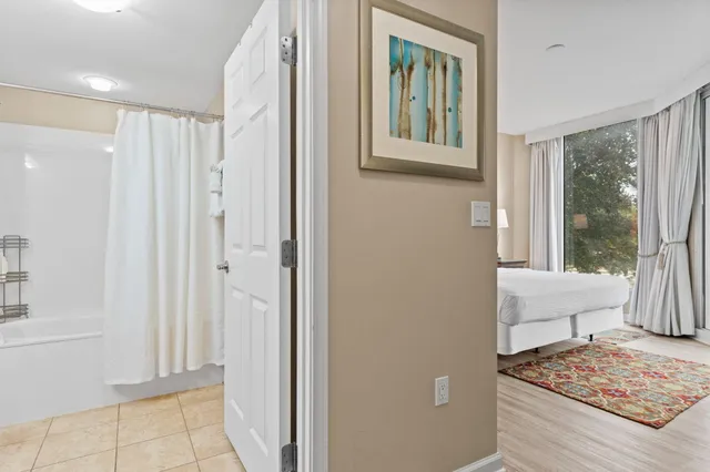 a living room with furniture and a painting on the wall