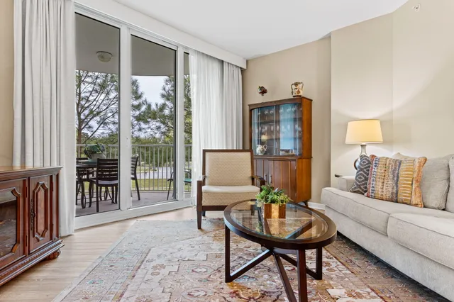 a living room with furniture wooden floor and a table
