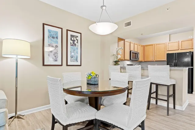 a kitchen with stainless steel appliances granite countertop a stove a sink a microwave a refrigerator a counter space and cabinets