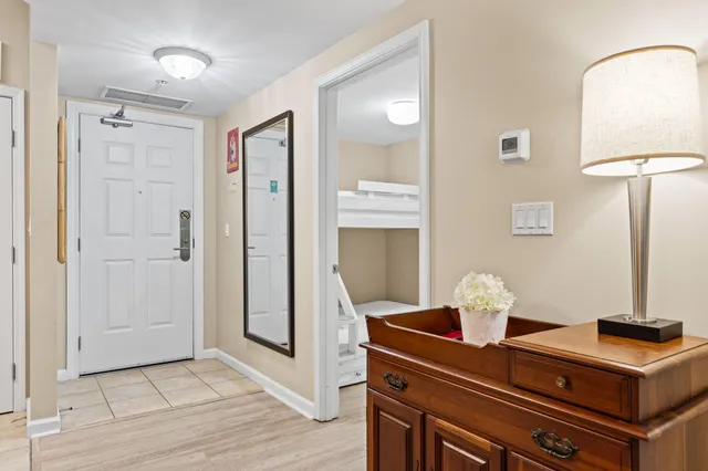 a bedroom with a bed and a view of kitchen