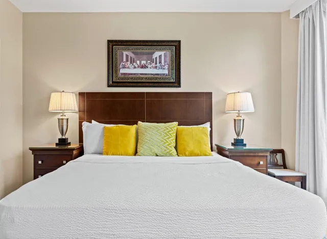 a bedroom with a bed and a large window