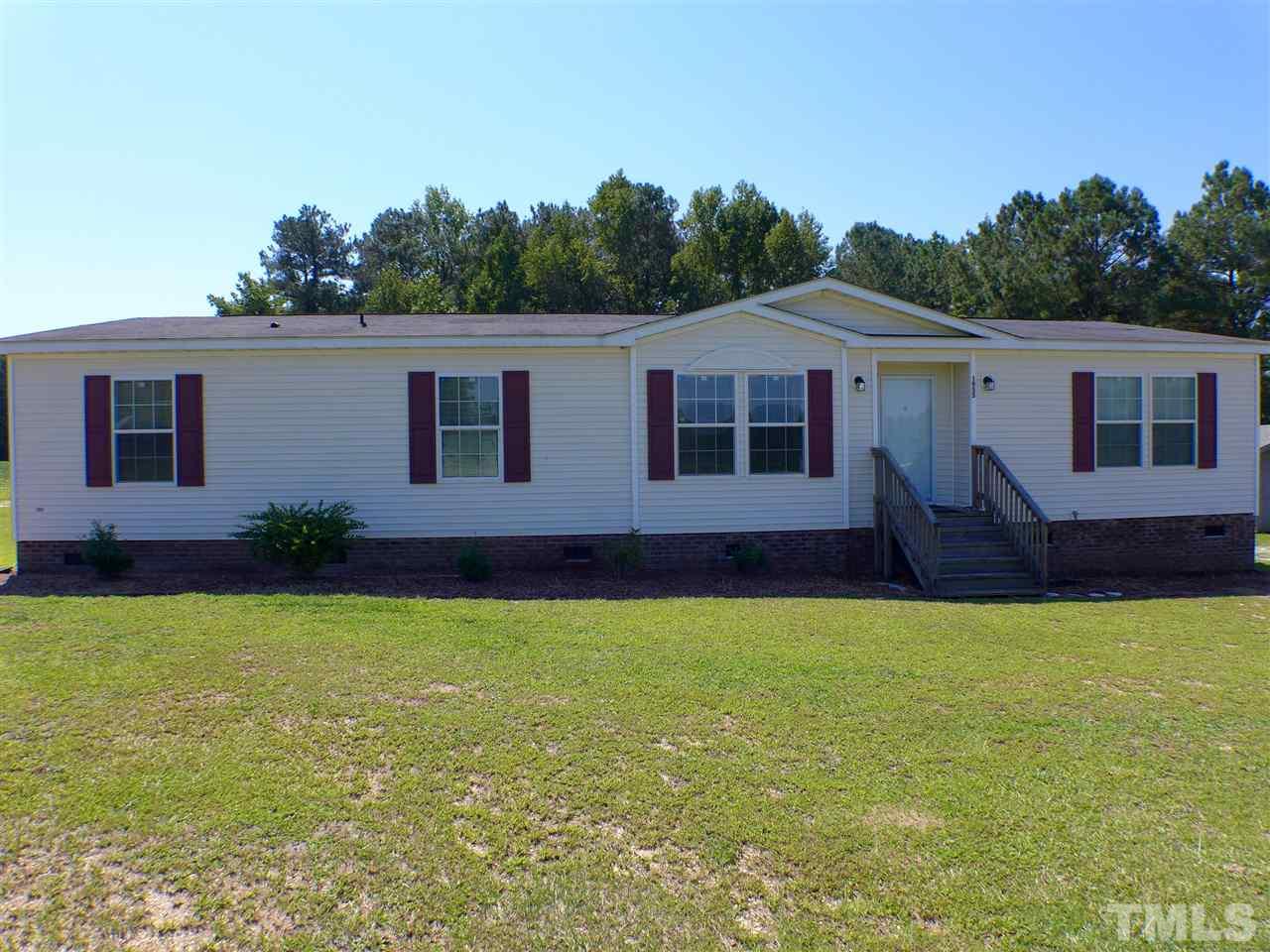 1955 Holly Grove Road Benson, NC 27504 - Photo 2 of 25 a house that has a big yard with wooden fence