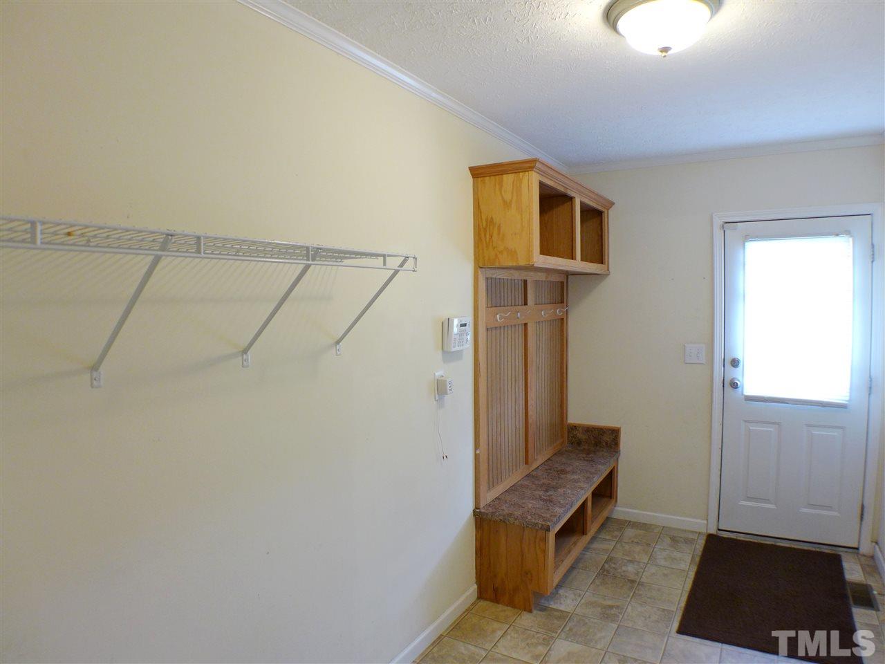 1955 Holly Grove Road Benson, NC 27504 - Photo 11 of 25 a view of an entryway with wooden floor