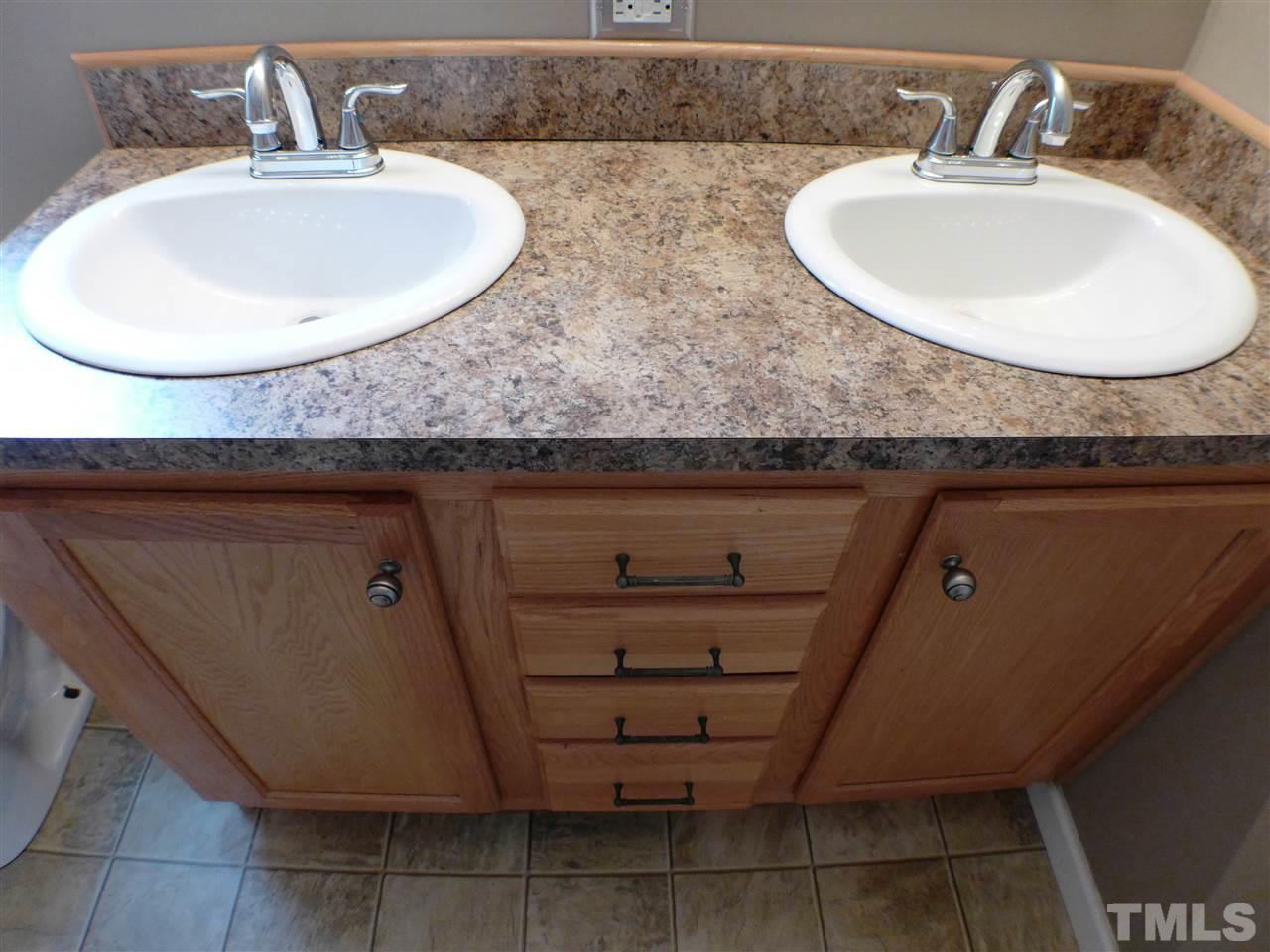 1955 Holly Grove Road Benson, NC 27504 - Photo 14 of 25 a bathroom with a sink and a mirror