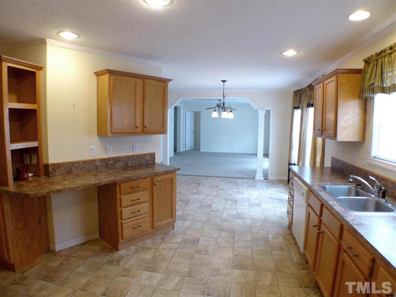 1955 Holly Grove Road Benson, NC 27504 - Photo 20 of 25 a large kitchen with kitchen island a sink stainless steel appliances and cabinets