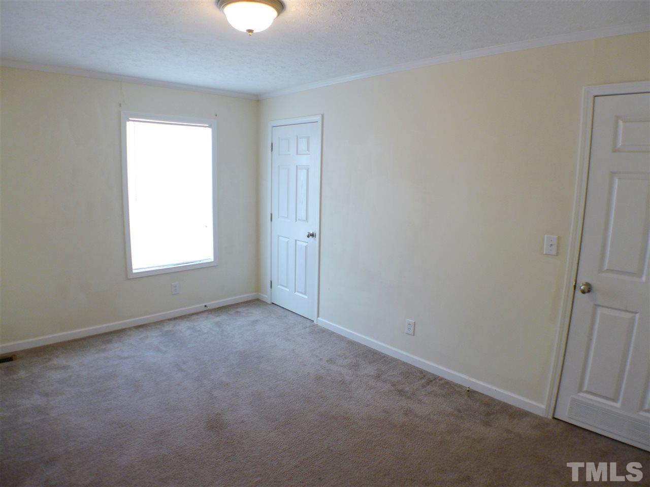 1955 Holly Grove Road Benson, NC 27504 - Photo 22 of 25 an empty room with windows and closet
