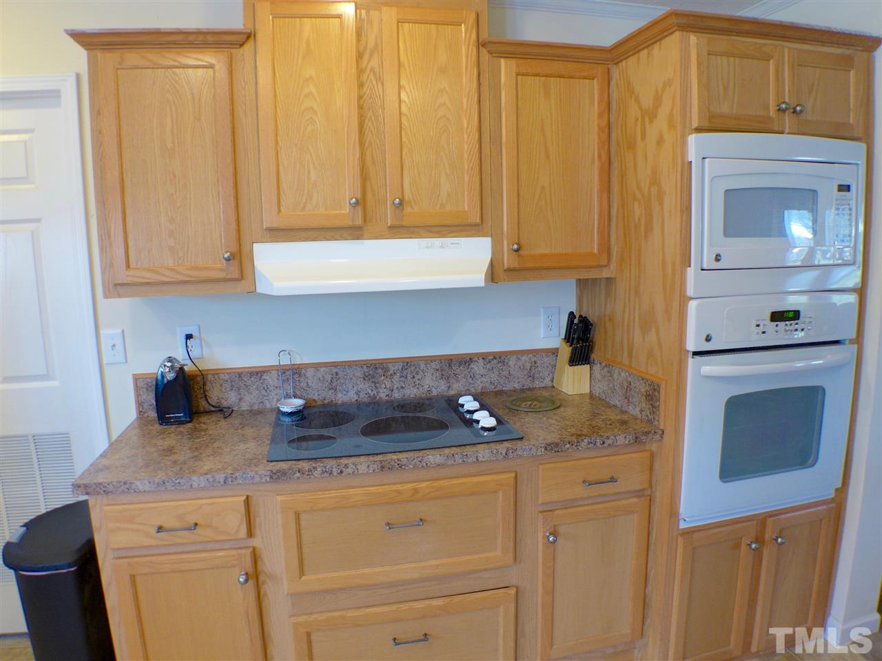 1955 Holly Grove Road Benson, NC 27504 - Photo 8 of 25 a kitchen with granite countertop white cabinets and white appliances