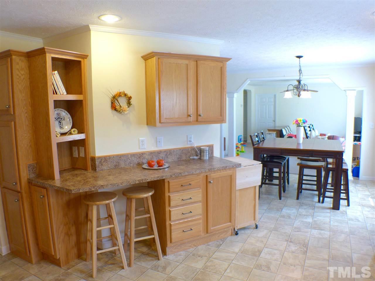 1955 Holly Grove Road Benson, NC 27504 - Photo 10 of 25 a view of a kitchen area with cabinets and wooden floor