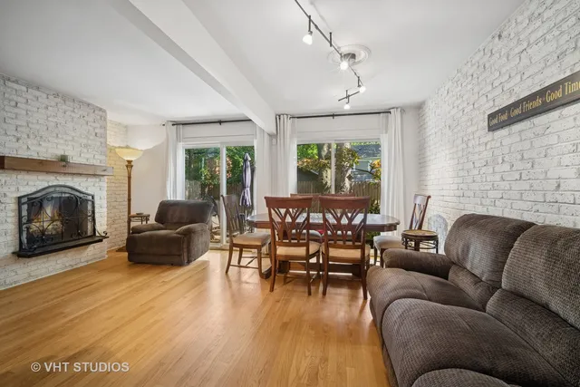 a living room with furniture fireplace and a large window