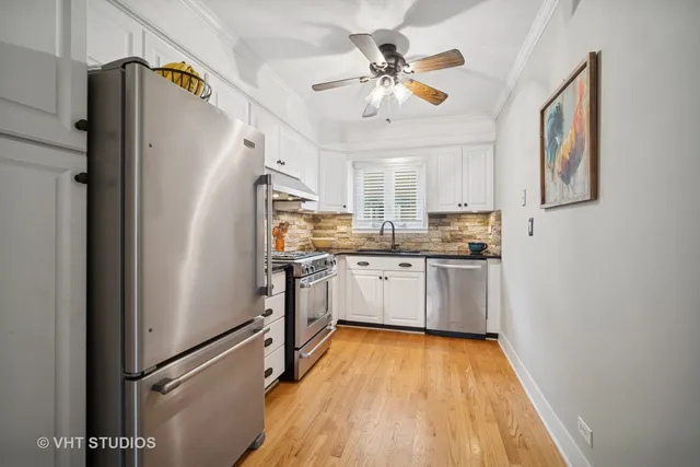 a kitchen with stainless steel appliances a refrigerator sink and microwave