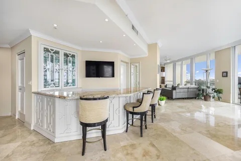 a living room with furniture a window and a flat screen tv