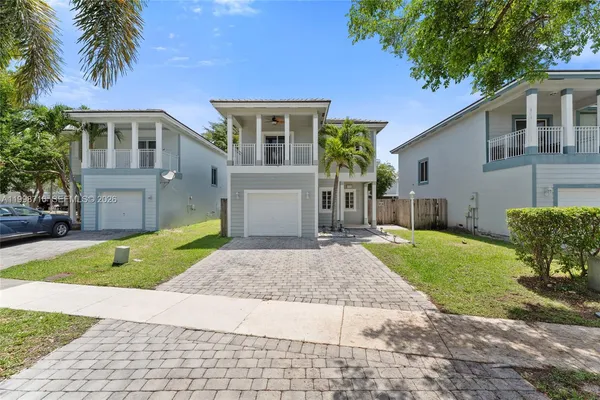 a front view of a house with a yard and porch