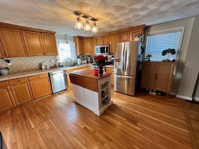 3 Pinecrest Road North Reading, MA 01864 - Photo 17 of 37 a kitchen with stainless steel appliances granite countertop a refrigerator a oven a sink dishwasher and wooden cabinets with wooden floor