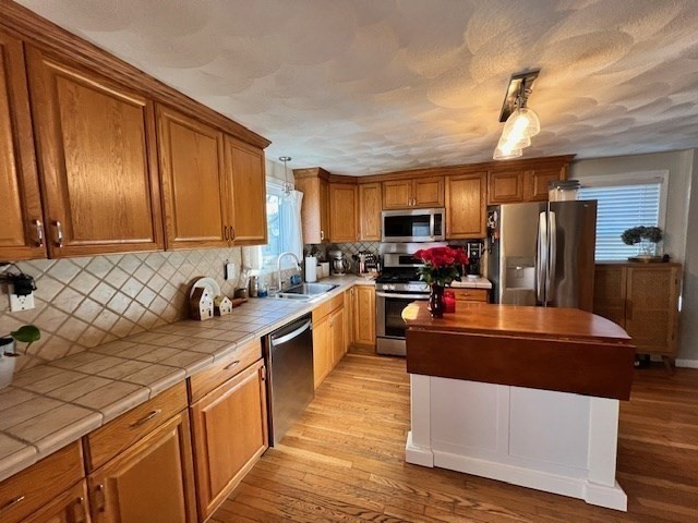 3 Pinecrest Road North Reading, MA 01864 - Photo 20 of 37 a kitchen with stainless steel appliances granite countertop a sink stove microwave and refrigerator