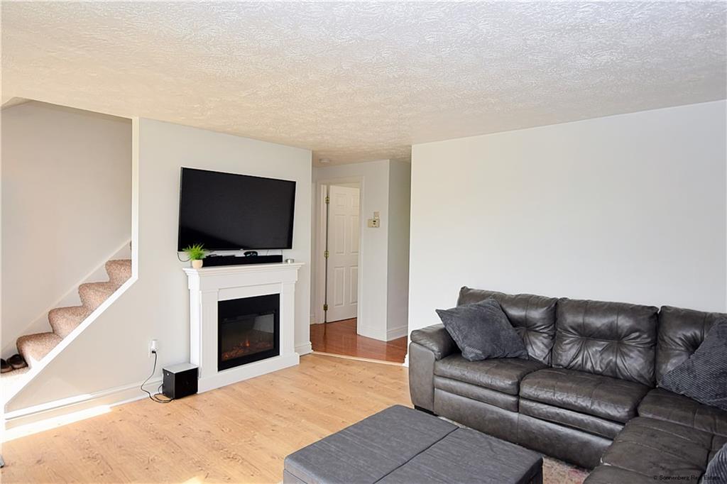 508 Countryside Drive McKees Rocks, PA 15136 - Photo 2 of 25 a living room with furniture a flat screen tv and a fireplace