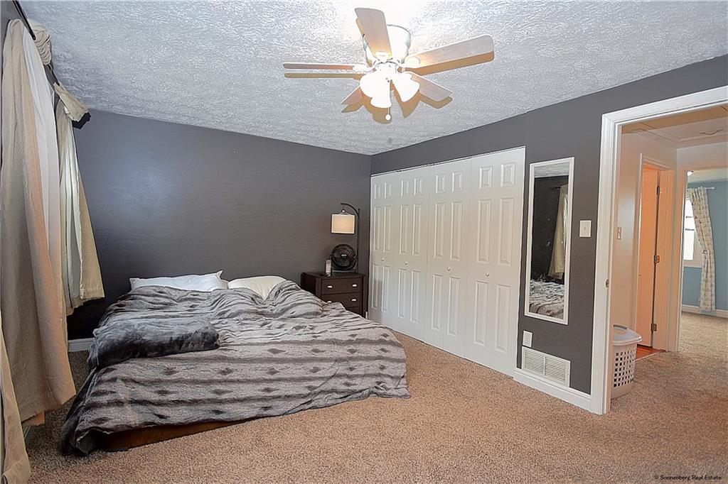 508 Countryside Drive McKees Rocks, PA 15136 - Photo 9 of 25 a bedroom with a bed and a chandelier