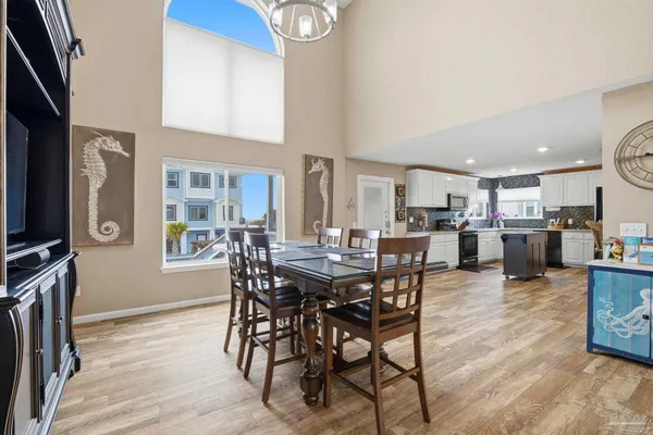 a view of a dining room with furniture and a flat screen tv