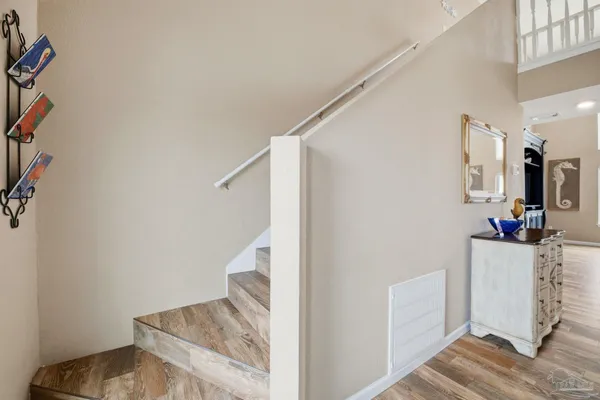 a view of a hallway with wooden floor and entryway