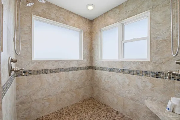 a bedroom that has a bed and a dresser in it