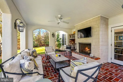 a living room with fireplace furniture and a large window