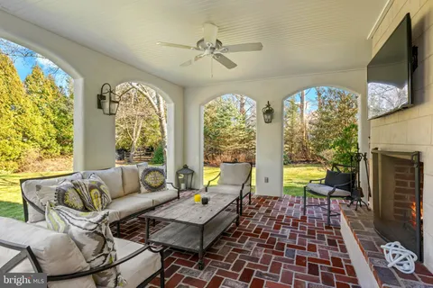 a living room with patio furniture and a large window