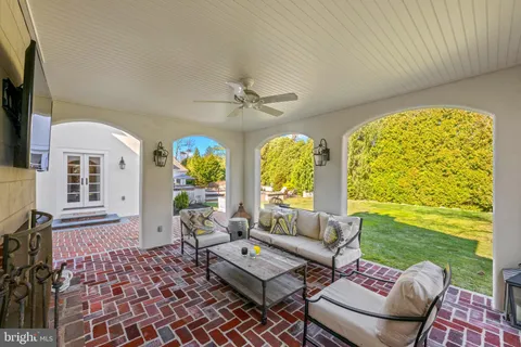 a view of a patio with table and chairs potted plants with wooden fence