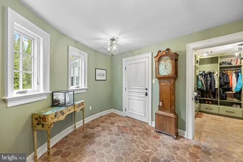 a spacious bathroom with a granite countertop sink and a mirror