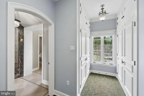 a view of a hallway with closet and bathroom