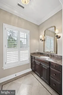 a bathroom with a toilet a sink and a mirror