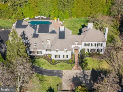 an aerial view of a house with yard swimming pool and outdoor seating