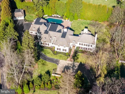 an aerial view of a house with a swimming pool