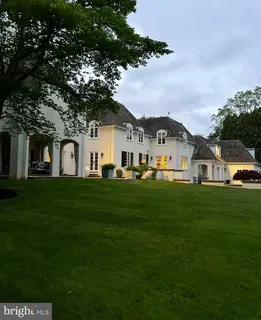 a living room with furniture fireplace and a large window