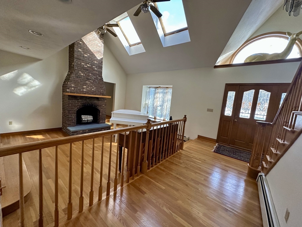 42 Pine Acres Road Foxboro, MA 02035 - Photo 8 of 40 a view of an entryway with wooden floor fireplace and a front door