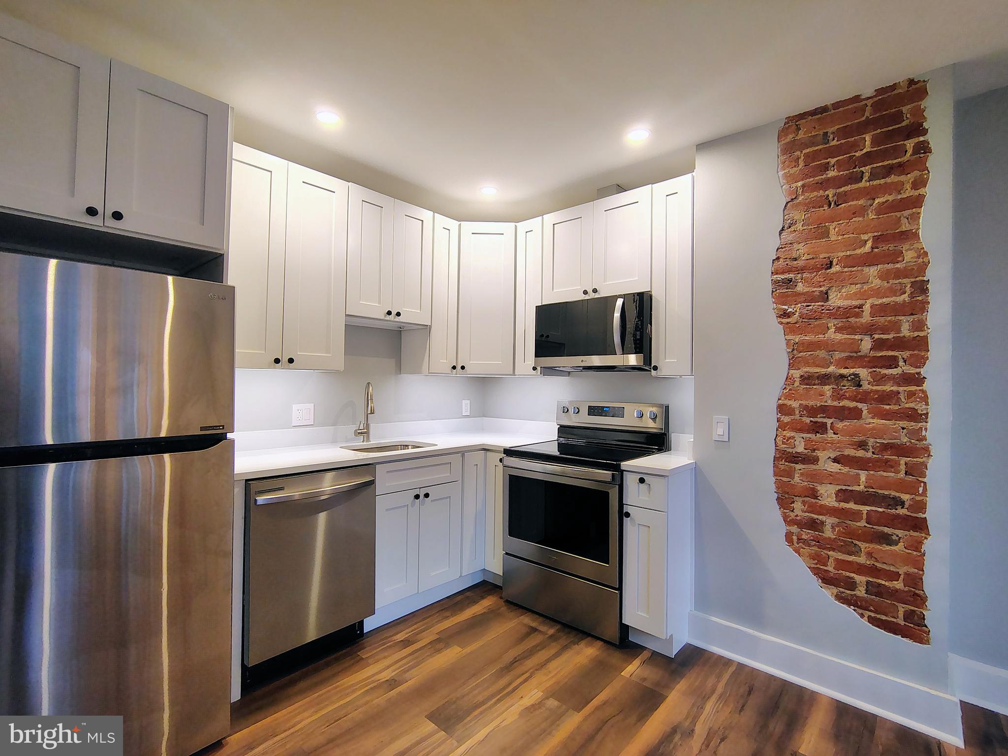 230 South Market Street, Unit 3 Frederick, MD 21701 - Photo 1 of 16 a kitchen with stainless steel appliances a refrigerator sink and microwave