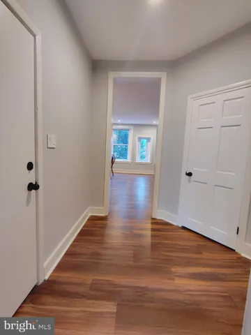 a view of an entryway with wooden floor