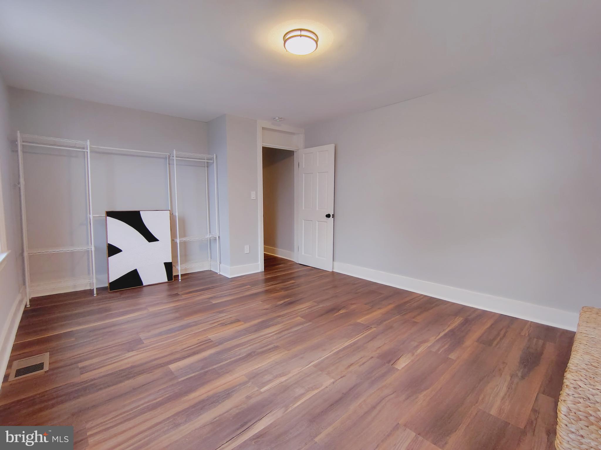 230 South Market Street, Unit 3 Frederick, MD 21701 - Photo 10 of 16 a view of an empty room with wooden floor and white walls